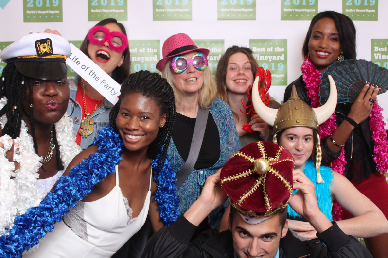 Colorfully costumed winners pose in a photo booth at the Best of the Vineyard party.